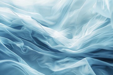 Fototapeta premium Elegant, soft blue fabric unfurling in graceful, fluid waves, creating an ethereal and tranquil visual effect reminiscent of serene ocean currents.