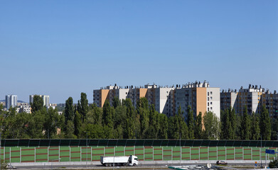 Bloki mieszkalne apartamentowiec między drzewami, ekrany dźwiękochłonne.