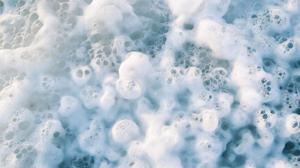 a close-up, top-down view of sea foam, filling the entire frame with the focus on the natural, white frothy bubbles formed by ocean waves