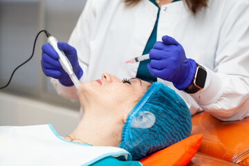 Application of an anti-aging facial rejuvenation cocktail using micro needles. Dermatology concept....