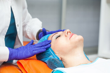 Application of an anti-aging facial rejuvenation cocktail using micro needles. Dermatology concept....