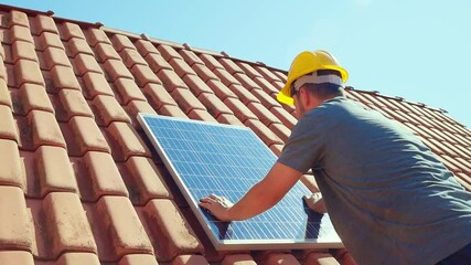 Technician installing a solar panel on a house roof, showcasing renewable energy solutions and sustainable living. Ideal for companies promoting clean energy and solar power installations