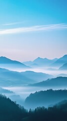 Obraz premium Misty mountain landscape with layers of blue hills in morning light, serene nature scene