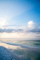 white sand and blue sky at the beach with clouds
