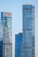 Naklejka premium Modern skyscrapers against the sky. View of residential and office high-rise buildings. Close-up.
