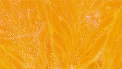 Slice an orange in bubble water. Slice of orange in carbonated water. Party concept, summer,...