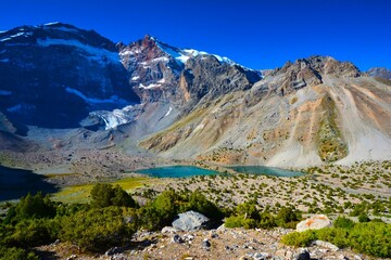 Dazzling blue Chimtarga Lake (Dushokha) seen while trekking at Kulikalon glacial tarns in the Fann Mountains (part of the western Pamir-Alay mountain system, Tajikistan's Sughd Province)