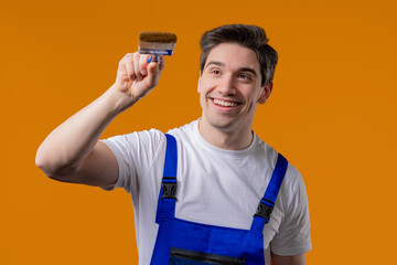 Creative handyman painter artist with brush on orange background. Fantasy, idea © kohanova1991