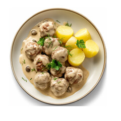 Meatballs and potatoes with sauce on plate closeup