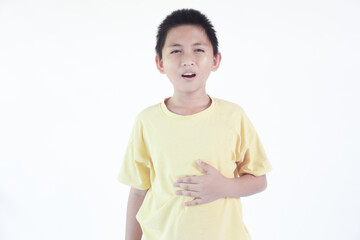 Asian little kid boy wearing yellow T-shirt standing indoor with hand on stomach because nausea, painful disease feeling unwell. Ache concept.