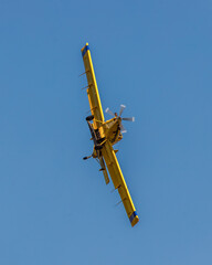 agricultural crop dusting aircraft approaches in a steep left bank at low altitude © david
