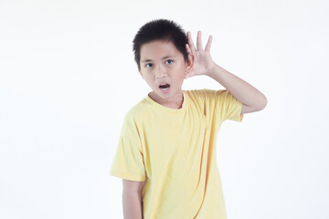 Little curious kid boy try to listening intently with hand on ear isolated on white background