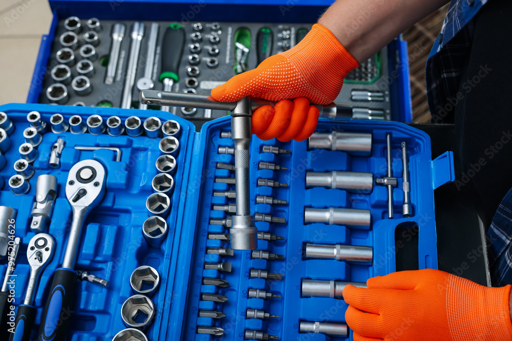 Canvas Prints Auto mechanic with different tools at automobile repair shop, closeup