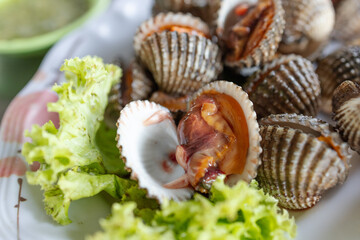 Top view of Boiled Cockle with seafood sauce, focus selective