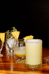 Refreshing cocktail on black background. Piñacolada and black friday.