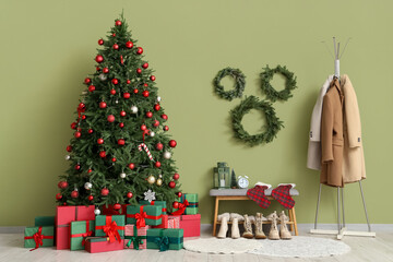 Interior of hallway with Christmas tree, soft bench and coat rack