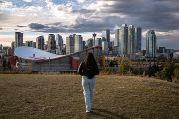 woman walking towards city