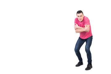 Shivering man standing in studio with crossed arms