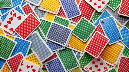 Fototapeta premium of colorful playing cards spread out on a table, game, deck, casino, gambling, poker, leisure, entertainment, fun, luck, strategy
