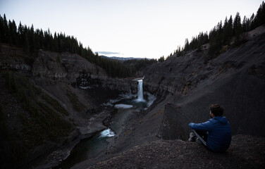 Fototapeta premium person watching the waterfall