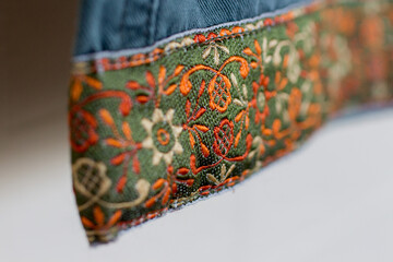Close-up of embroidered cuff on casual pants