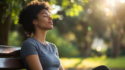 A woman sitting quietly on a park bench engaging in mindfulness for stress relief