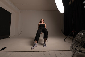 Portrait of a beautiful young red-haired girl in a studio.