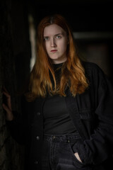 Fototapeta premium Portrait of a beautiful young red-haired girl in a studio.