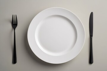 a white plate with a fork and knife                             