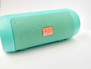 light blue portable bluetooth speaker on a white background.