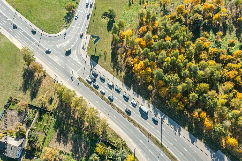 Wall mural aerial view of suburban highway in autumn sunny day. viewpoint from above with drone.