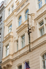 Abstract twisted metal drainpipe on facade of building on Maiselova street in old part of Prague in Czech Republic