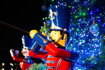 Christmas Decoration a trumpeter. Christmas time with the tree lit up and looking through the soldier with trumpets. Symbol of Christmas. Vintage toy Christmas soldier.