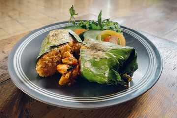 Indonesian food Nasi bakar ayam kemangi or grilled rice with basil chicken
