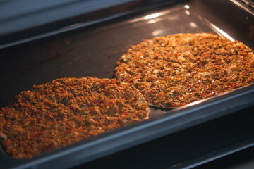Homemade pizza is baked in a modern electric oven.