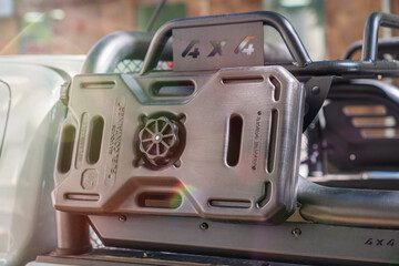 Cose-up view of a rugged 4x4 vehicle roof rack featuring mounted off-road equipment, fuel container...