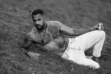 Sexy Man in grass farm on countryside. Sexy Farmer with bare naked torso. Muscular sexy farm worker...