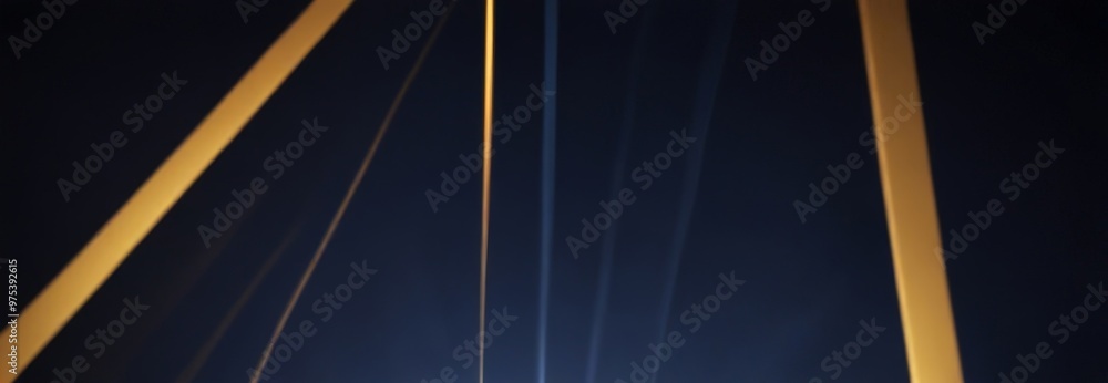 Poster a blurred, abstract composition of intersecting lines and beams of light against a dark background, 