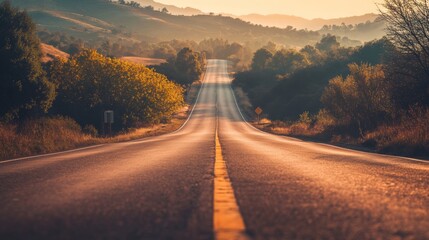 Obraz premium Winding Country Road Through Scenic Autumn Landscape at Sunset or Sunrise