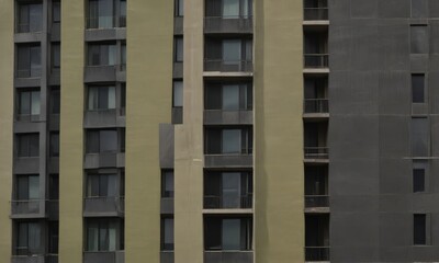 a close-up view of a multi-story building with a dark gray exterior and a lighter gray interior.