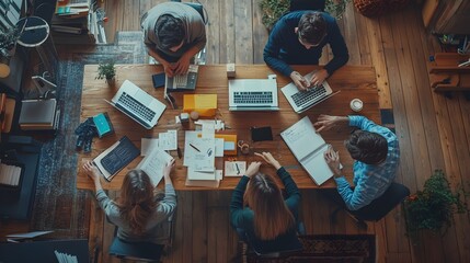 Four People Collaborating on a Project Around a Table