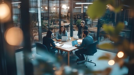 Four colleagues collaborating on a project in a modern office setting