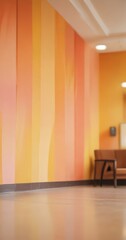 a vibrant orange and yellow striped wall in a room with a wooden floor and a blurred chair in the background.