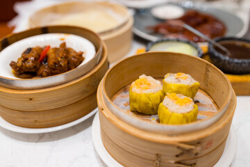 Cantonese style dim sum with steamed shumai in basket