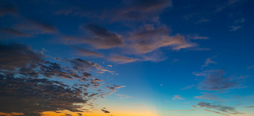 Sunset or sunrise. Dramatic majestic scenery sunset. Sky with clouds in sunset sky light background. Sunrise with clouds in various shapes. Calm sunset sky and sun through clouds over.