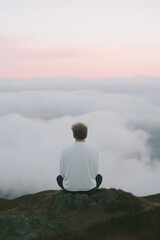 Fototapeta premium person sitting on a hill