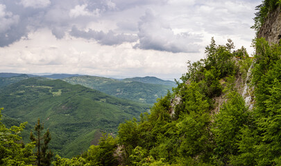 Obraz premium Forests in mountains with heavy clouds during summer