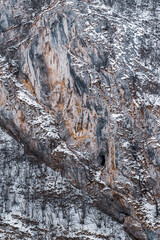 Entrance to a cave in a cliff during winter