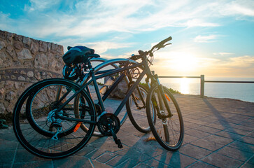 bike together to the beach on a sunset
