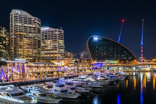 Sydney, Australia - April 16, 2022: Marriott W Sydney hotel as a part of Sydney City Darling Harbour skyline viewed through Cockle Bay Wharf while illuminated at night